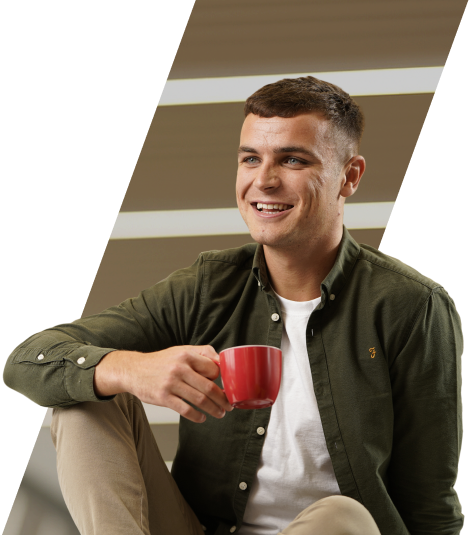A person holding a cup and smiling